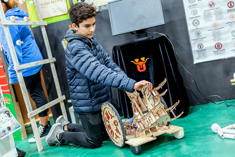 Photo of a student working on a robot