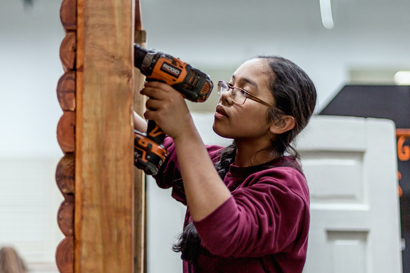 Photo of a student using a drill